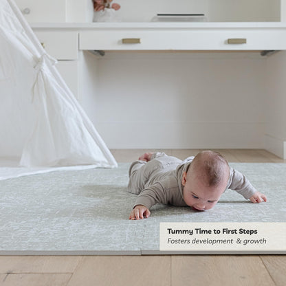 Water-resistant surface of Little Landings Eden play mat being cleaned