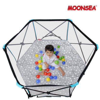 Moonsea plush baby play yard mattress being folded for portable storage.