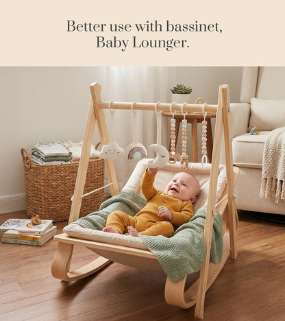 Mallify natural wood play gym folded completely flat to demonstrate its compact and portable storage design.