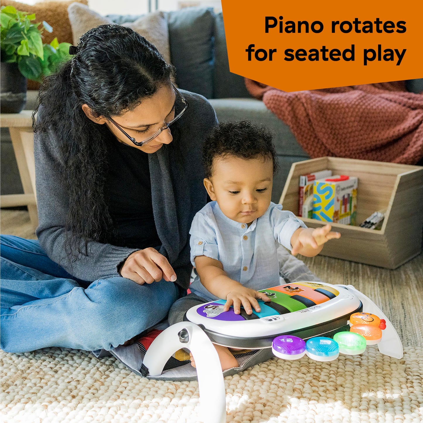 Toddler interacting with the portable on-the-go music piano detached from the play gym frame.
