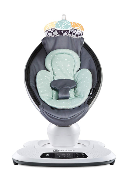 4moms infant insert attached to a baby swing showing harness fit