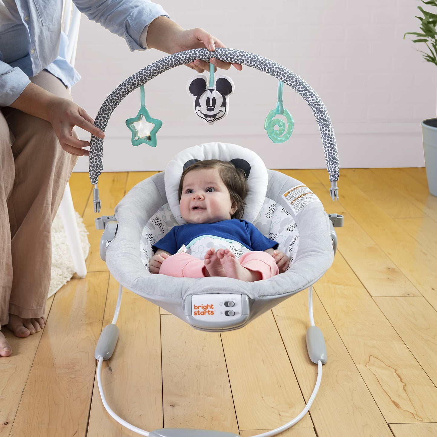 Infant sitting comfortably in the Winnie the Pooh bouncer seat