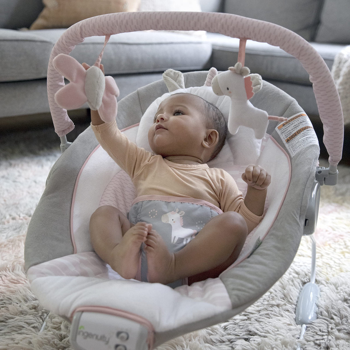 Ingenuity baby bouncer infant seat showing plush seat pad and side supports