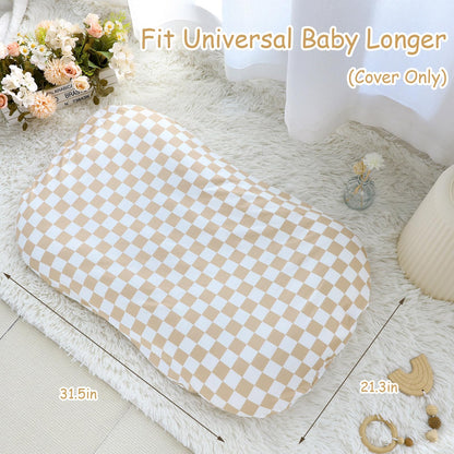 Light brown checkerboard baby lounger cover folded on nursery surface