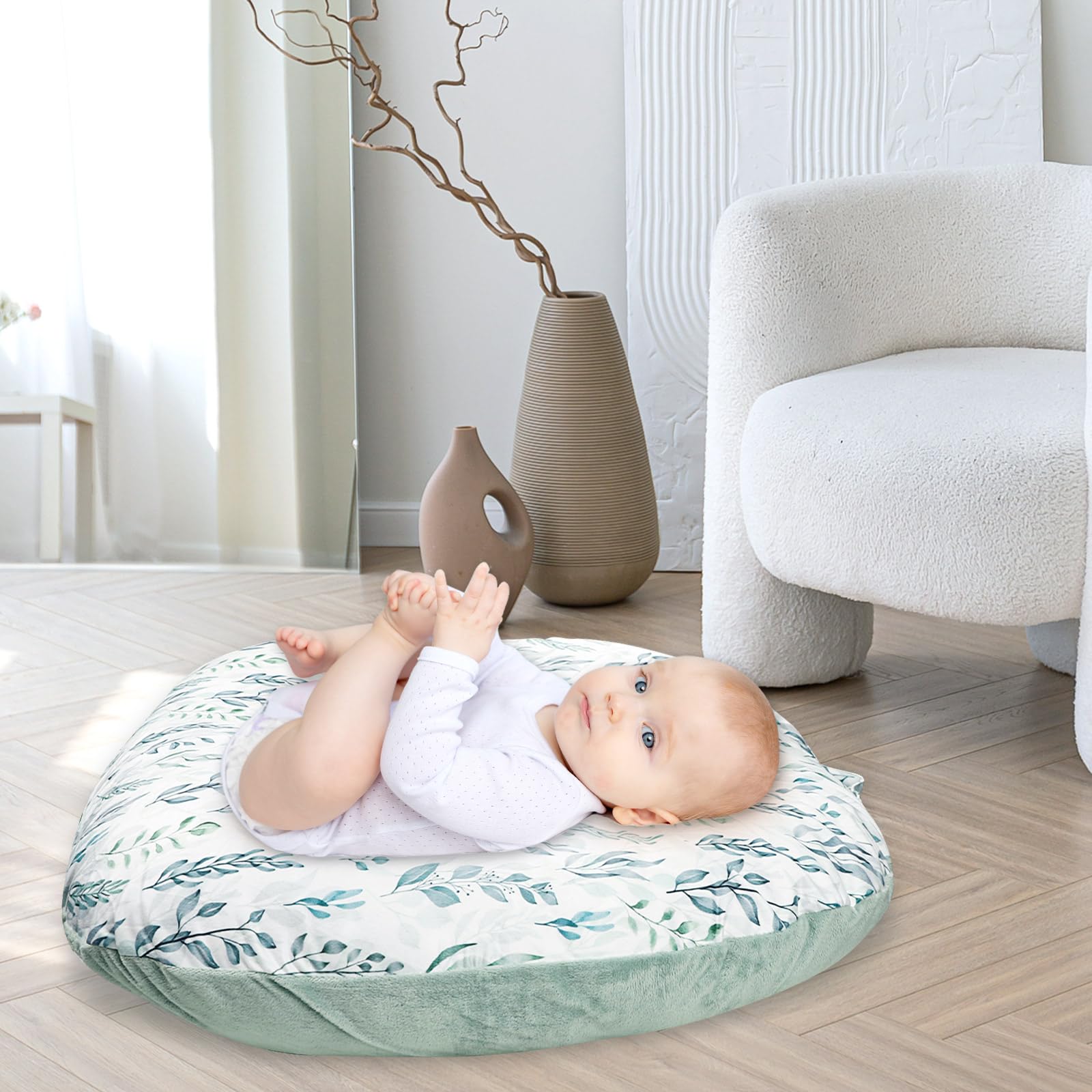 Lifestyle shot of baby lounger with decorative green leaf cover