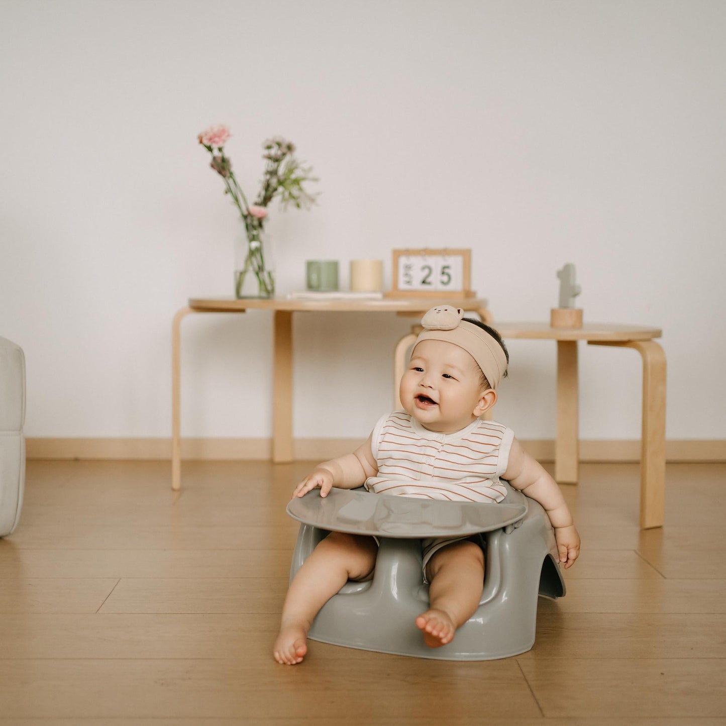 Bumbo infant seat placed on floor for baby playtime