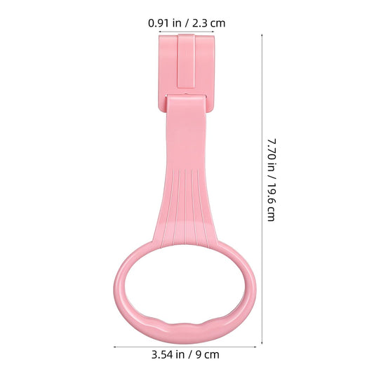 Infant holding onto white pull up ring for standing practice