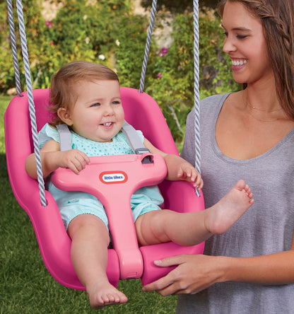 Close up of adjustable safety straps on pink baby swing