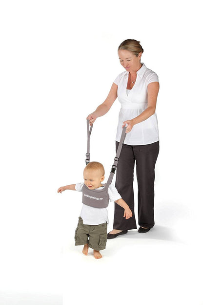 Parent using UpSpring Baby Walking Wings to assist toddler walking