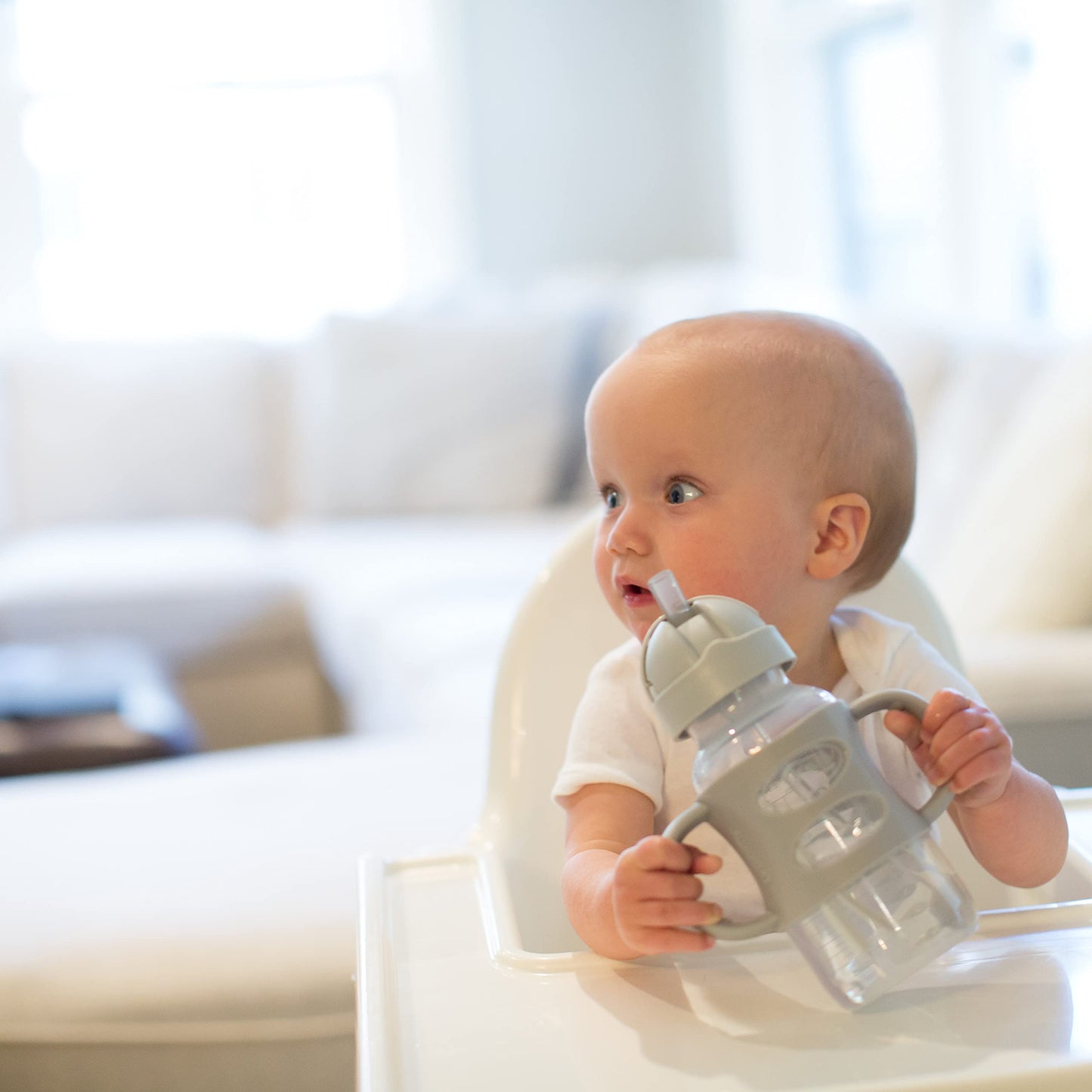Toddler holding Dr. Brown's Milestones sippy cup