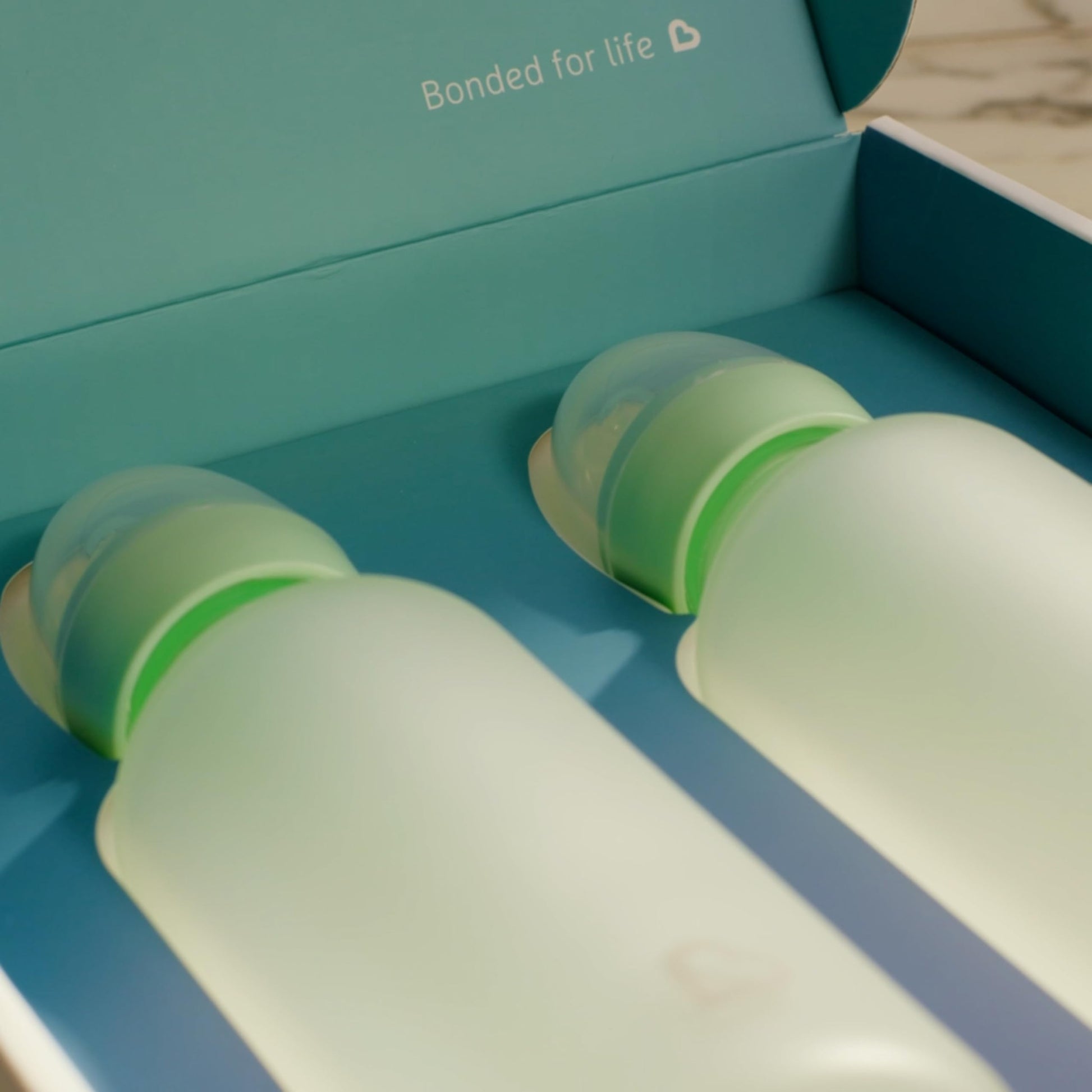 Munchkin Bond 2 pack white infant bottles with dust caps on display