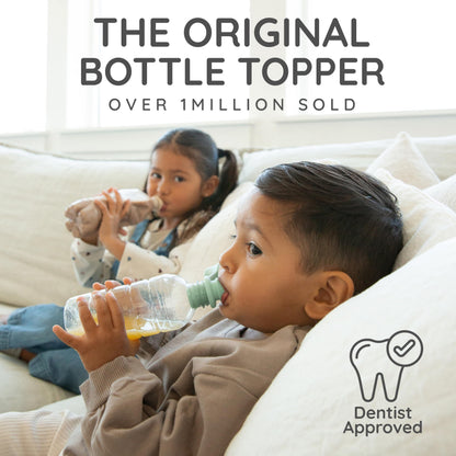 Toddler using Kiddikap spill proof bottle topper on a water bottle