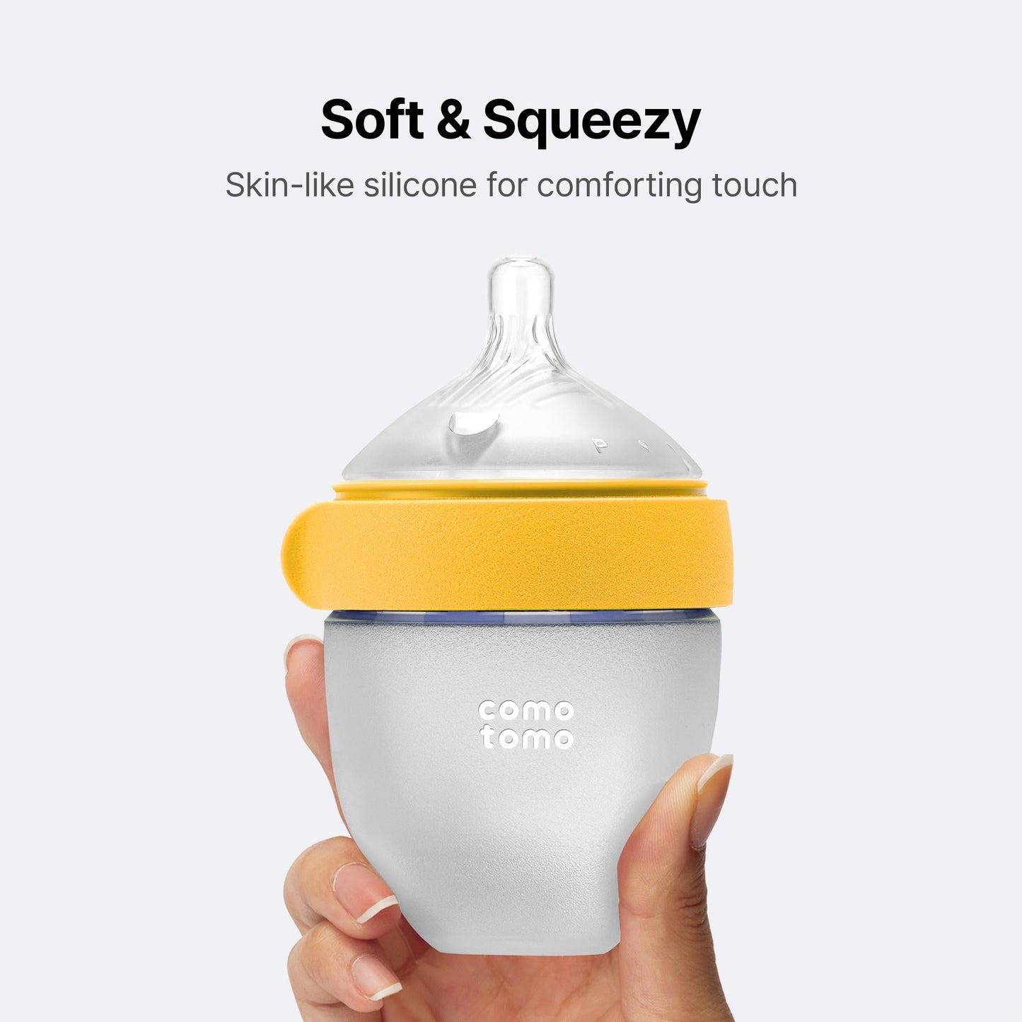 Side view of Comotomo yellow five ounce feeding bottle mimicking breast texture for easy transition.