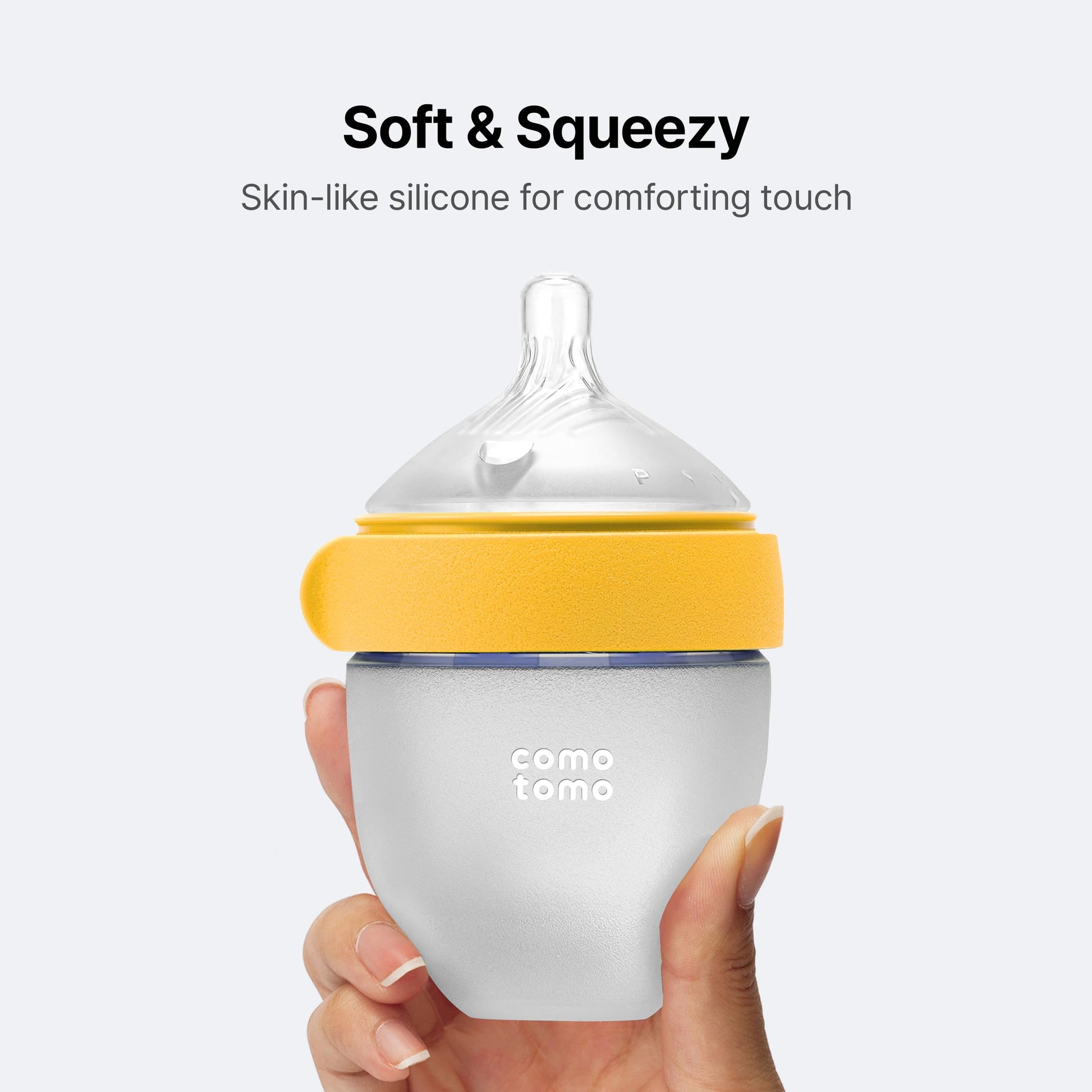 Side view of Comotomo yellow five ounce feeding bottle mimicking breast texture for easy transition.