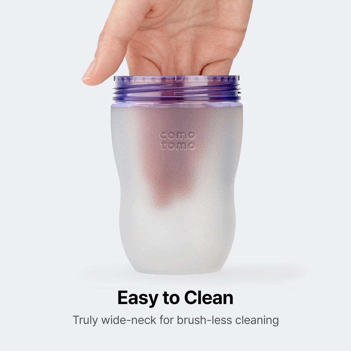Both green silicone feeding bottles from the double pack displayed together with their protective caps on.