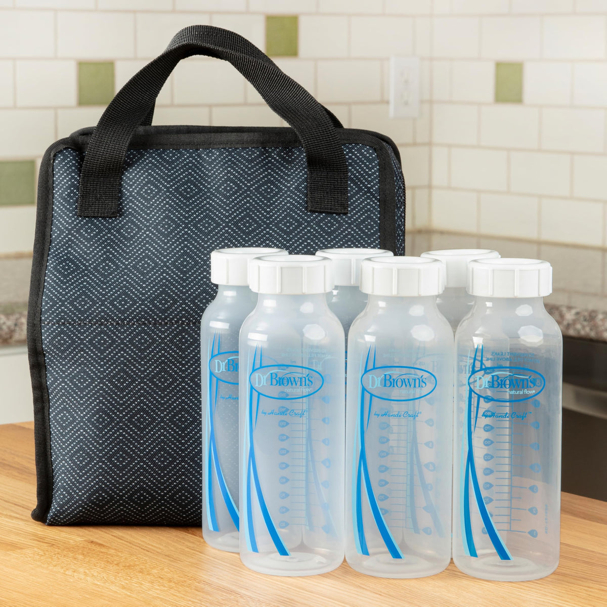 Dr. Brown's bottle cap positioned beside a narrow baby bottle