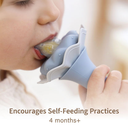 Infant using Moonkie silicone food feeder for self feeding