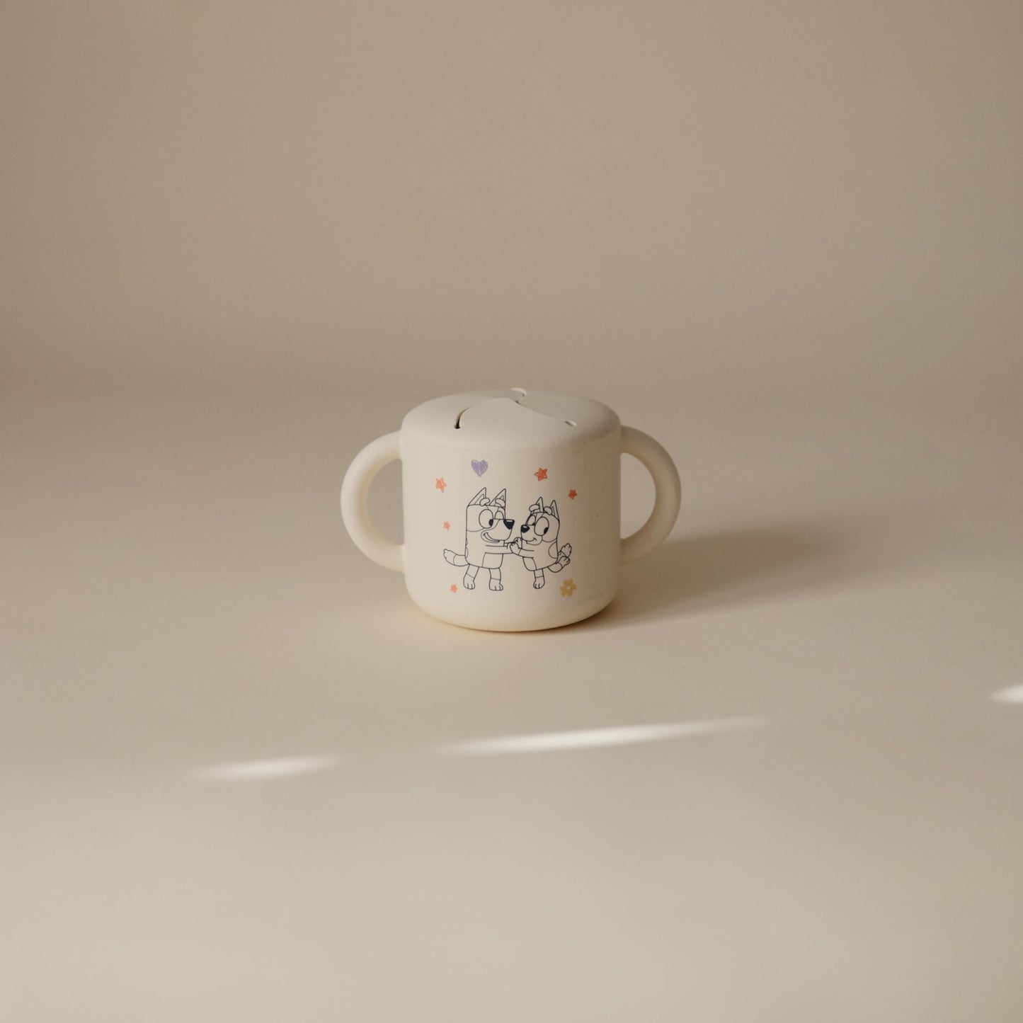 Mushie beige snack cup with easy-grip handles