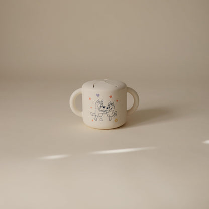Mushie beige snack cup with easy-grip handles