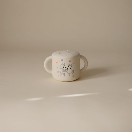 Mushie beige snack cup with easy-grip handles