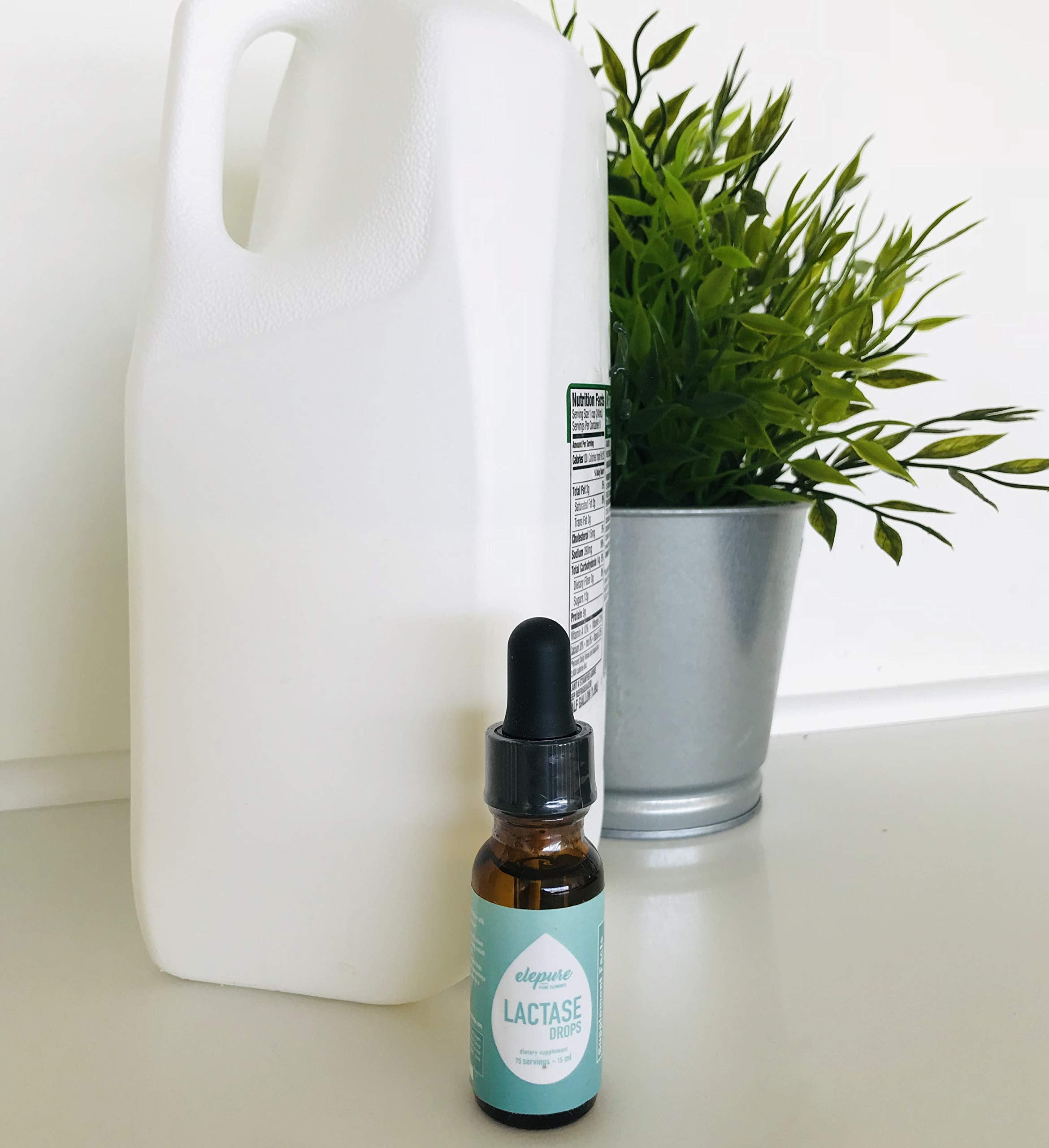 Side angle of Elepure twenty milliliter liquid enzyme bottle displaying ingredients and clear serving size information
