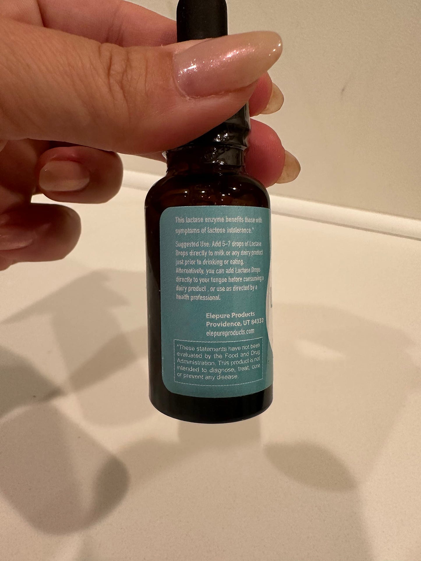 The complete retail packaging of Elepure liquid enzyme drops showcasing authentic American imported branding