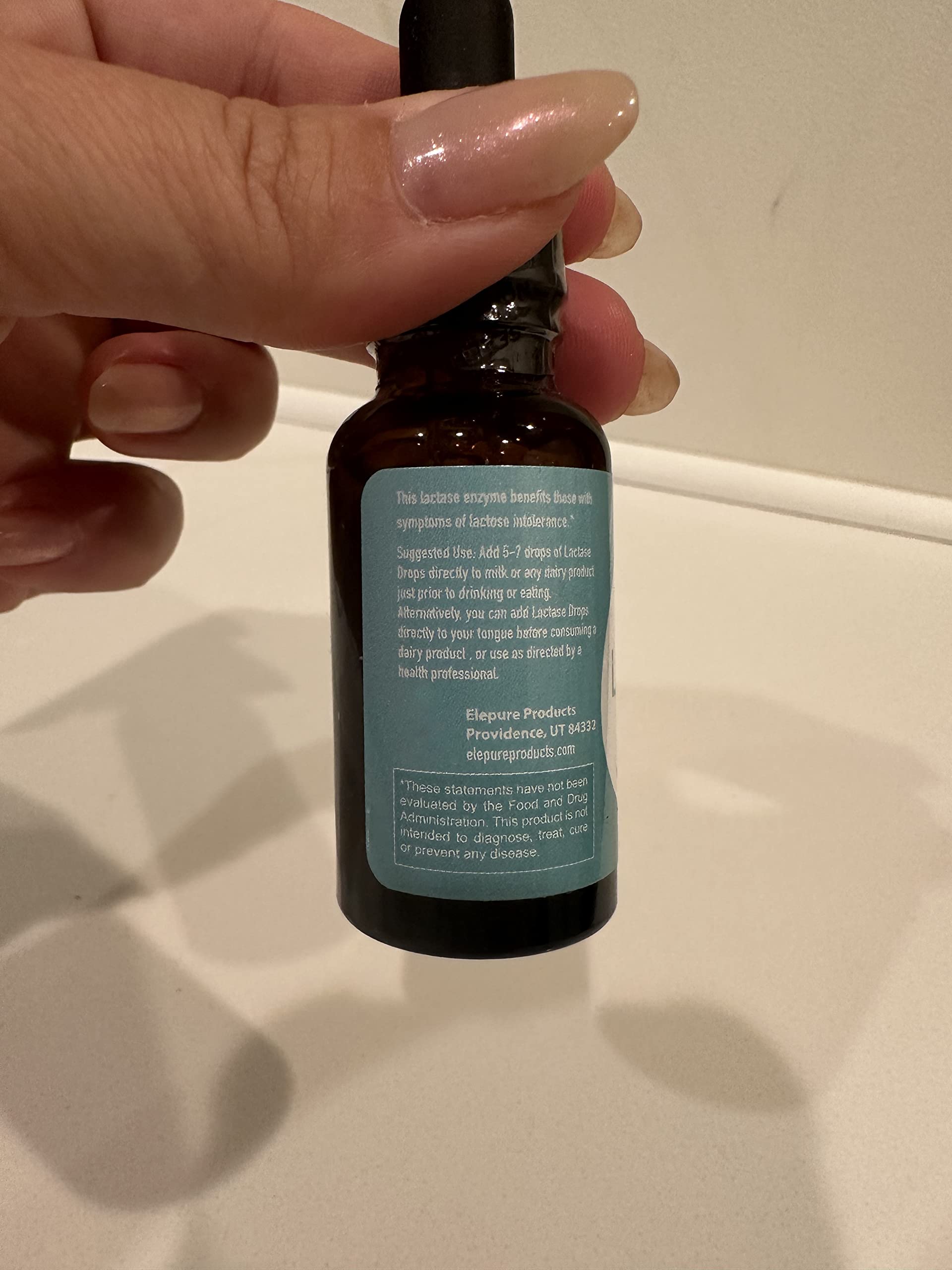 The complete retail packaging of Elepure liquid enzyme drops showcasing authentic American imported branding