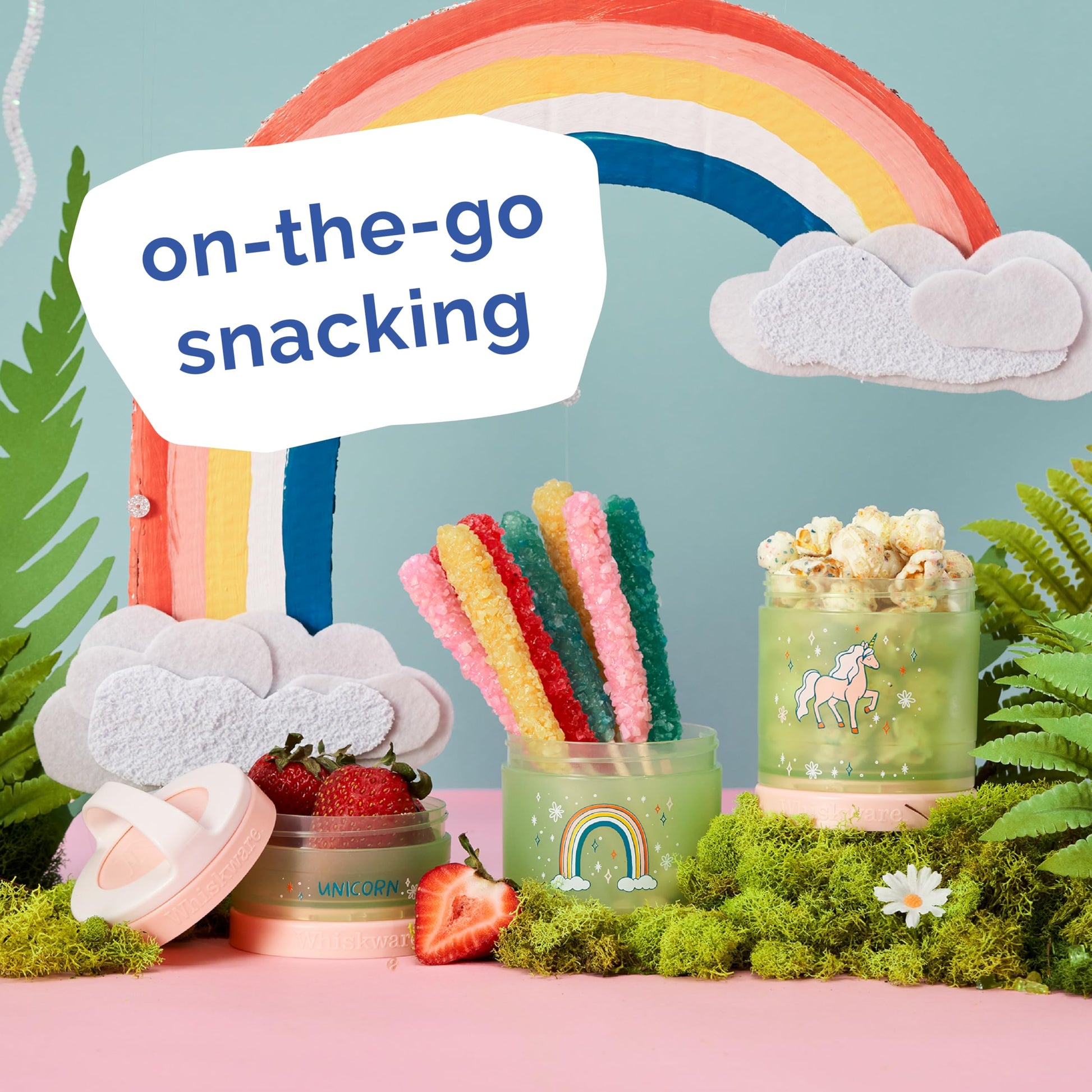 Whiskware snack cups clipped to a school backpack