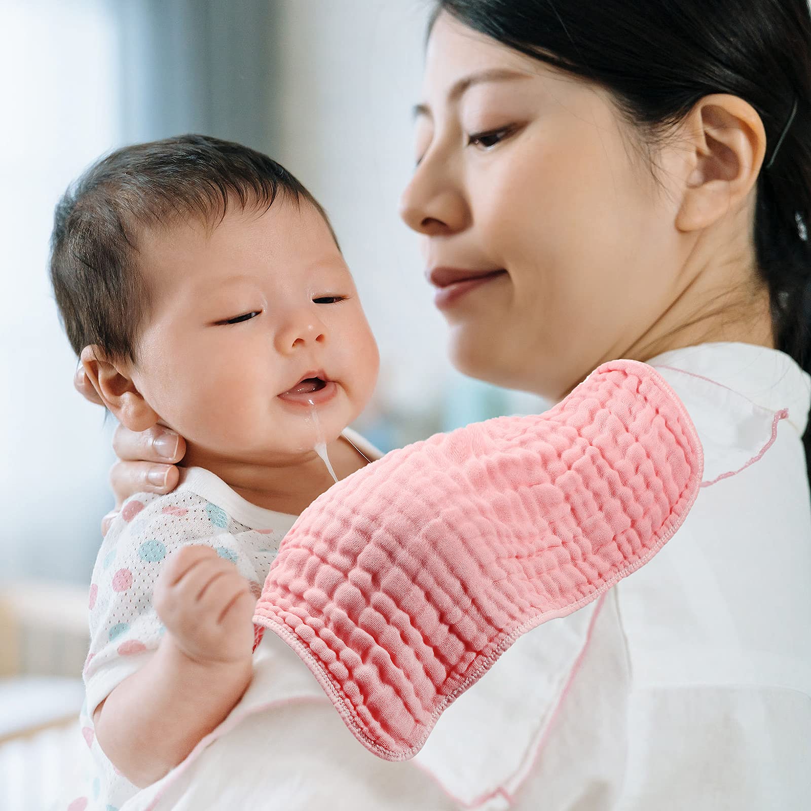 Tatuo soft muslin burp cloths draped over a nursery surface