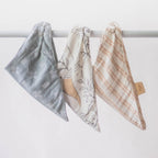 Top view of three unique Crane Baby muslin bib designs