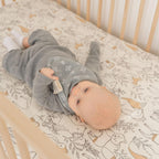 Close up of snap button closure on authentic Crane Baby bibs