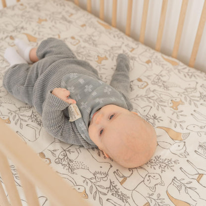 Close up of snap button closure on authentic Crane Baby bibs