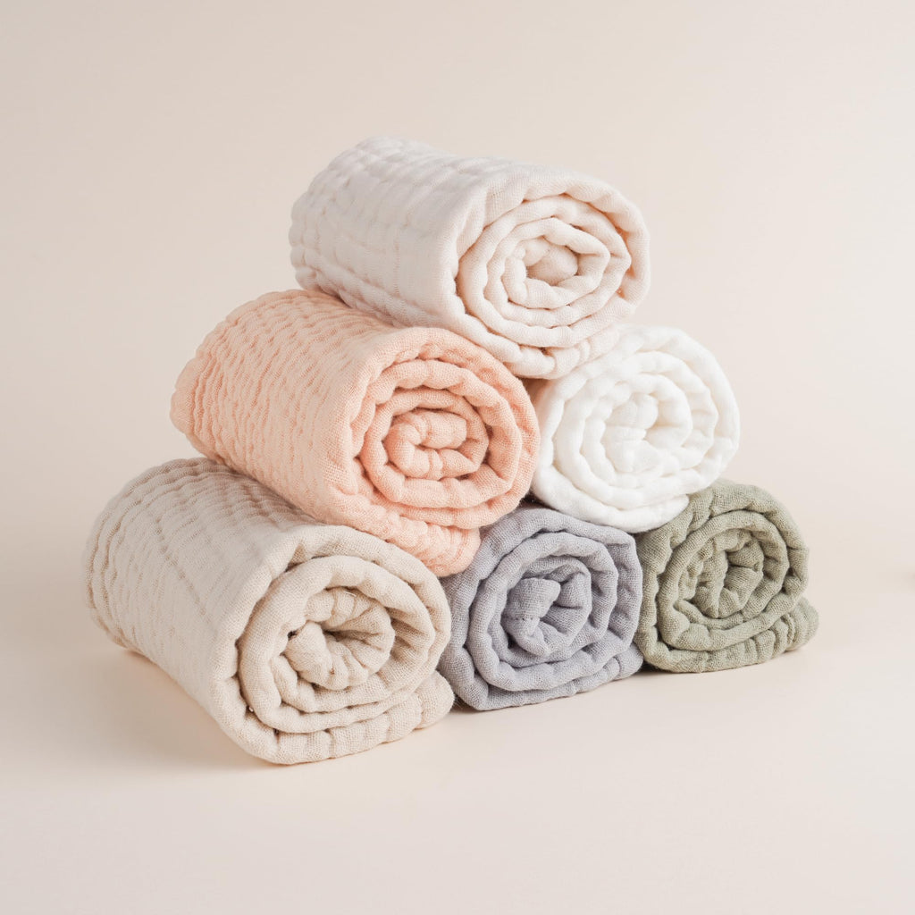 Soft absorbent muslin burp cloth being used as a washcloth