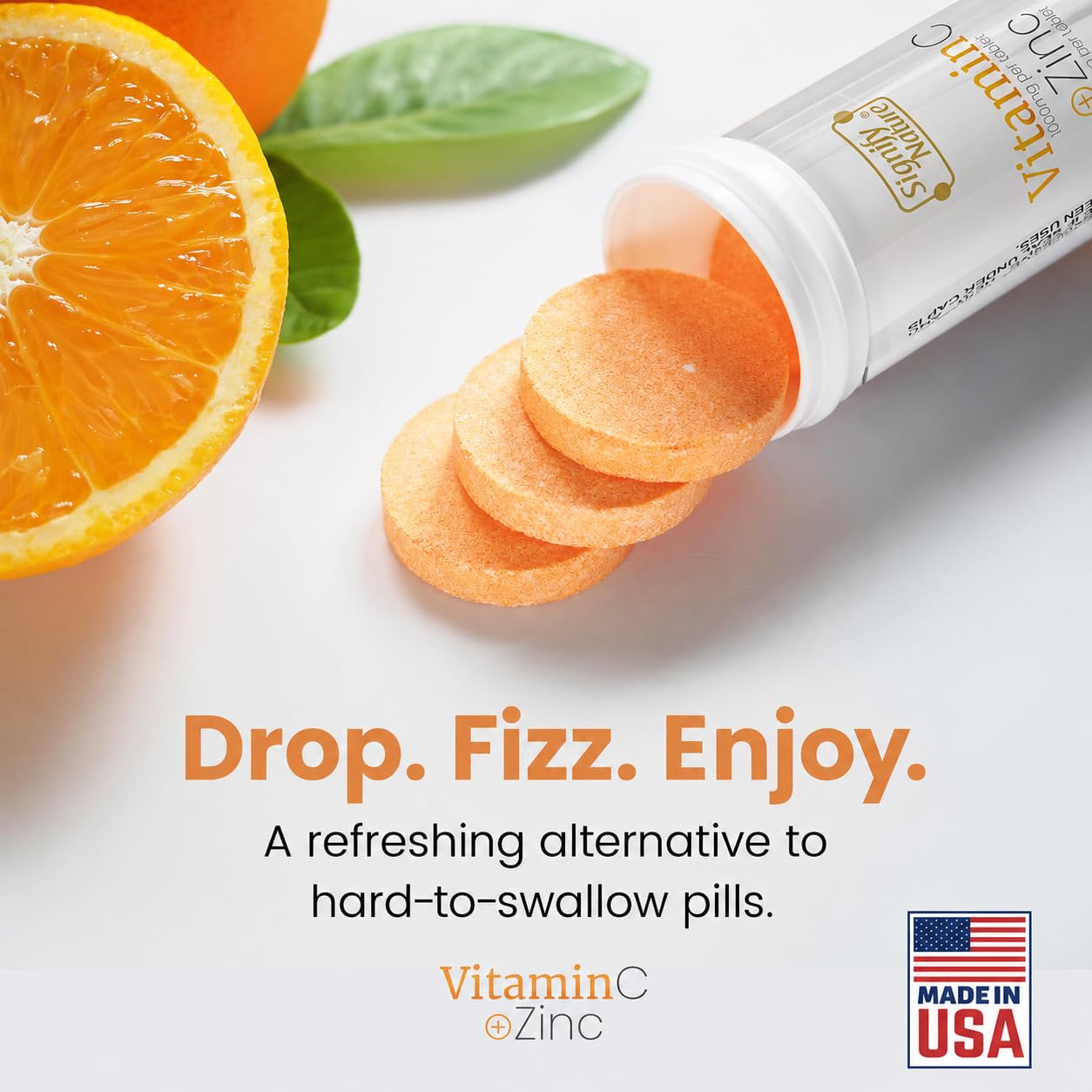 Fizzy orange immune drink being prepared by dissolving a Signify Nature sugar free tablet in water.