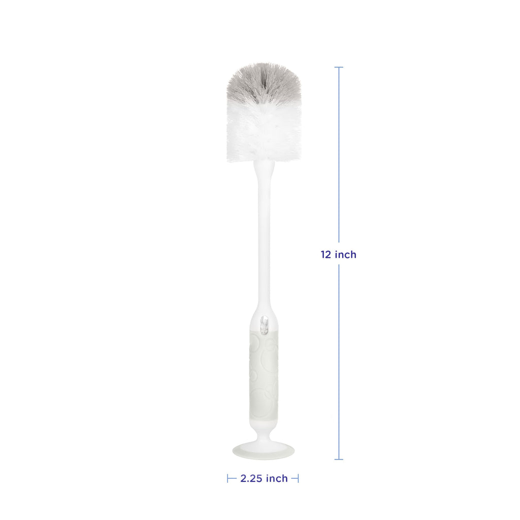 Ubbi bottle brush with suction cup base standing on counter
