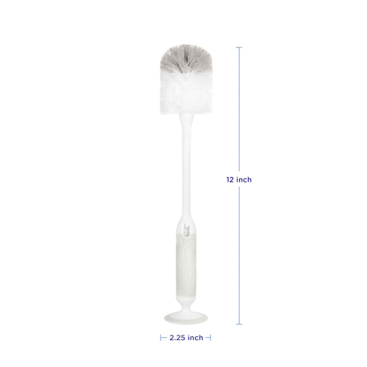 Ubbi bottle brush with suction cup base standing on counter