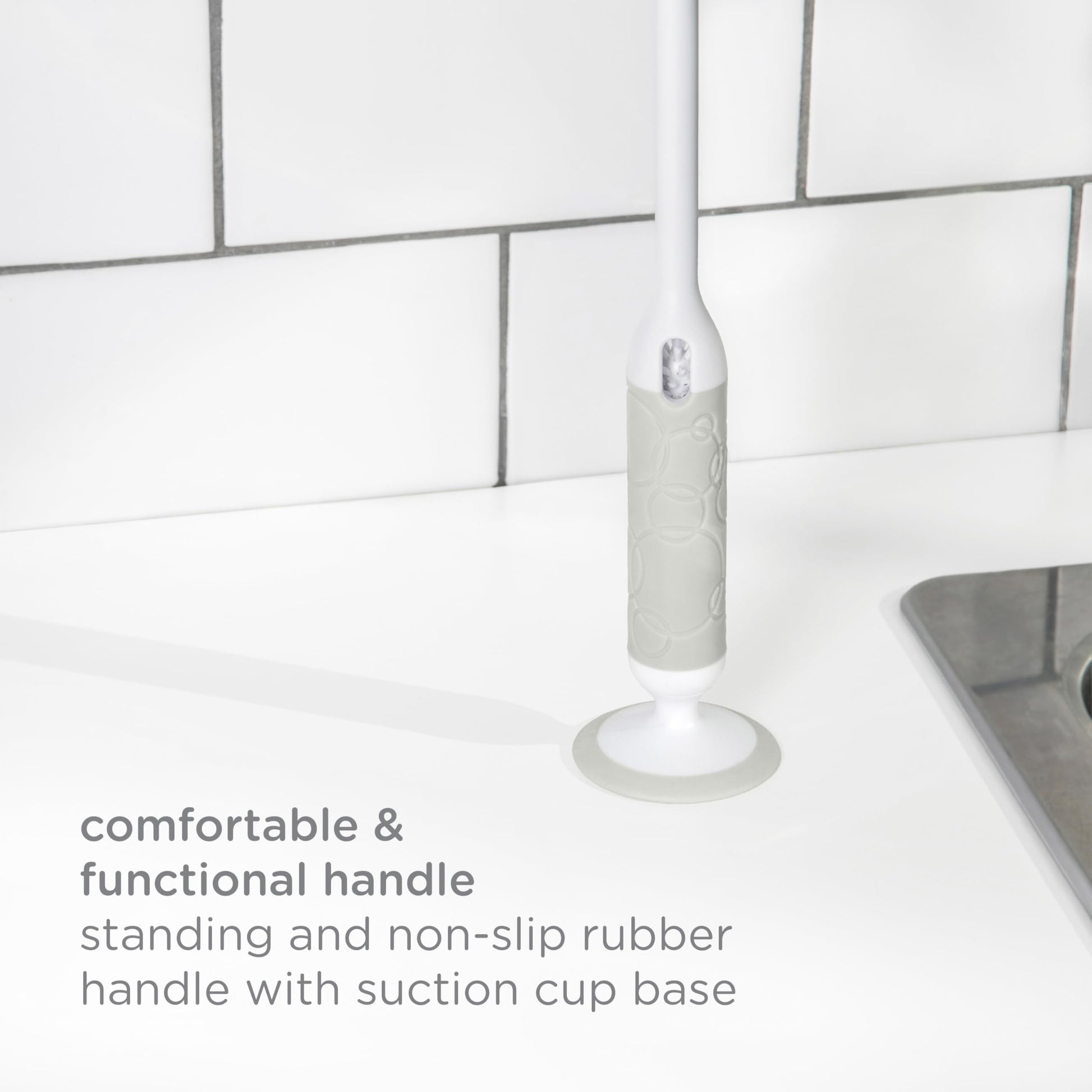 Integrated silicone nipple brush being removed from Ubbi handle