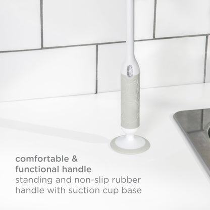Integrated silicone nipple brush being removed from Ubbi handle