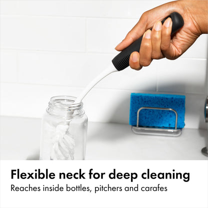 OXO bottle brush with flexible neck cleaning a glass pitcher