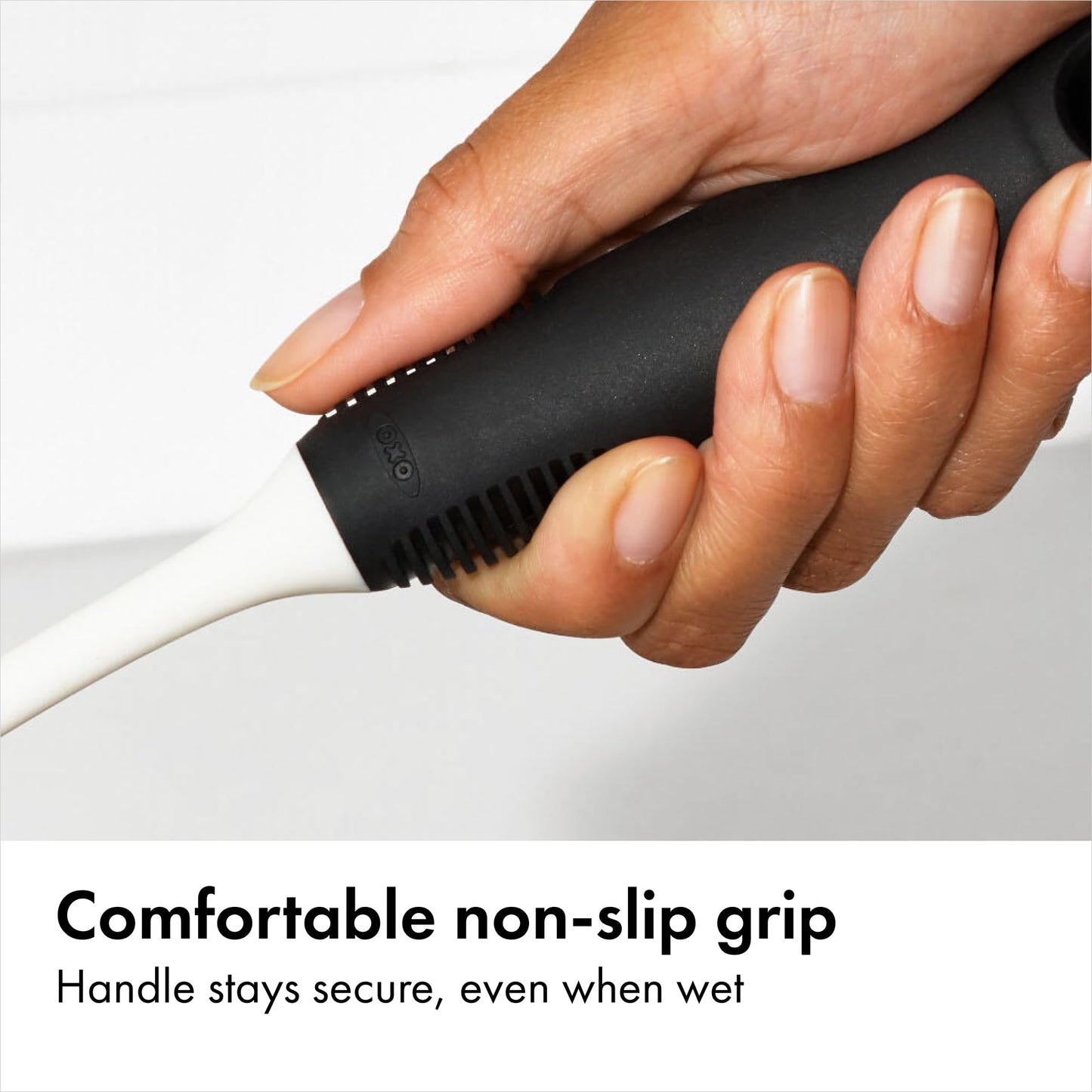 Close up of OXO dual-action nylon bristles and ergonomic handle