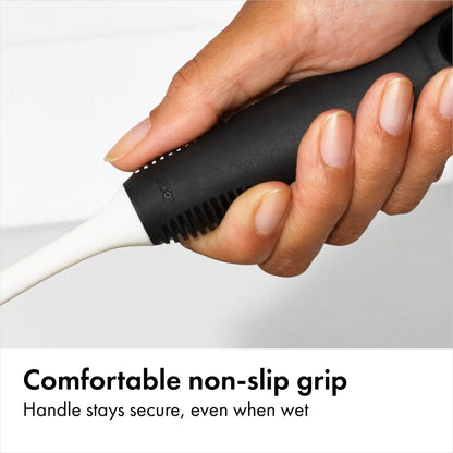 Close up of OXO dual-action nylon bristles and ergonomic handle
