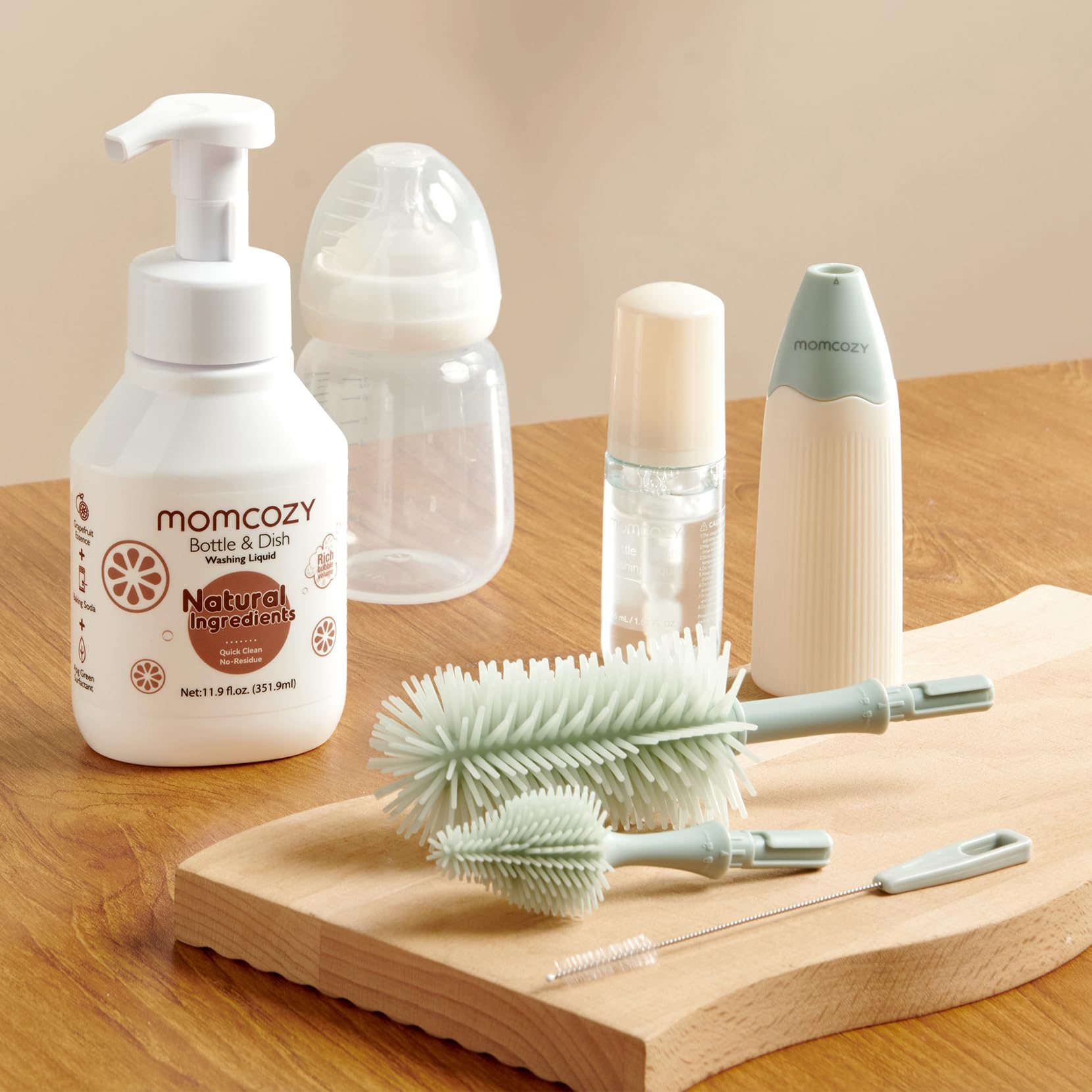 Momcozy cleaning fluid being used on baby bottle