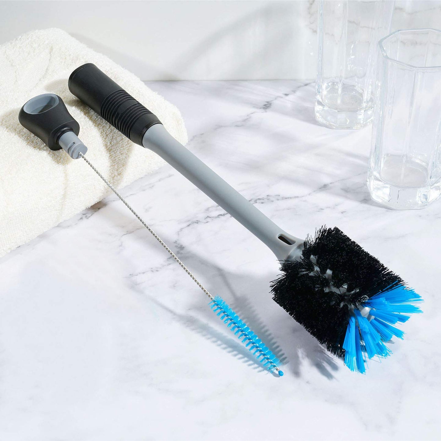Demonstration of the straw brush cleaning a reusable drinking straw.