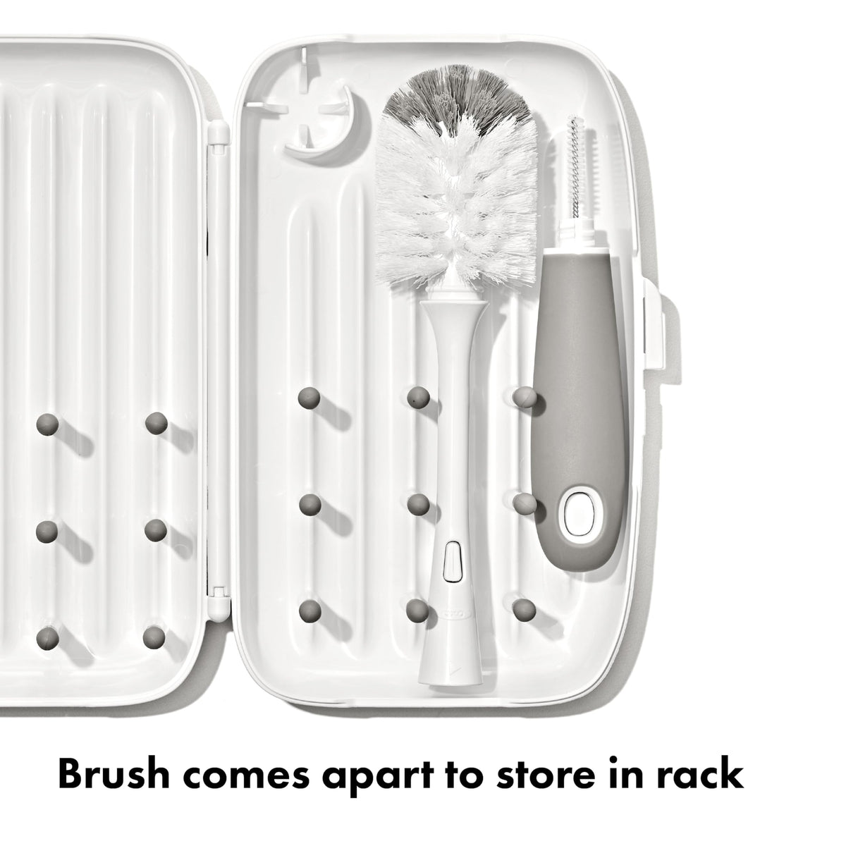 OXO Tot drying rack opened with baby bottles on pegs