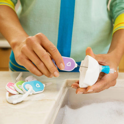 Using the Munchkin detail brush to clean sippy cup crevices