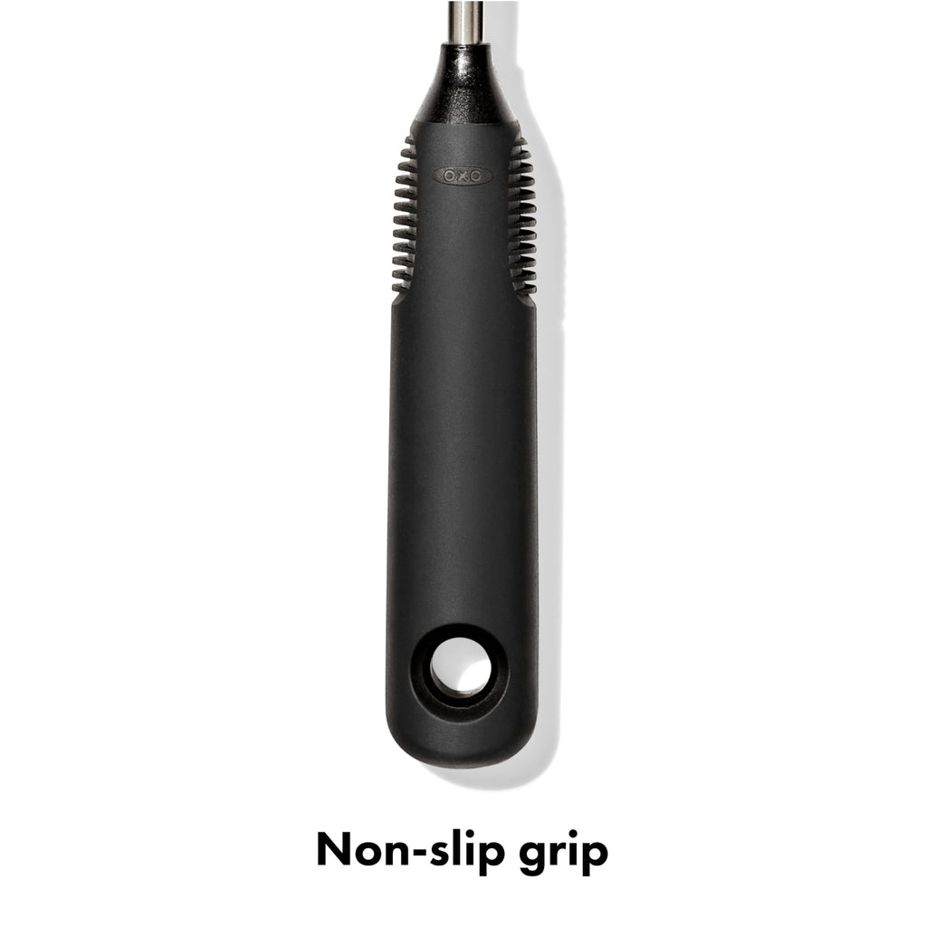 Hand holding OXO bottle brush with non-slip handle