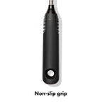 Hand holding OXO bottle brush with non-slip handle