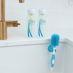Dr. Brown's brush cleaning a narrow-neck baby bottle