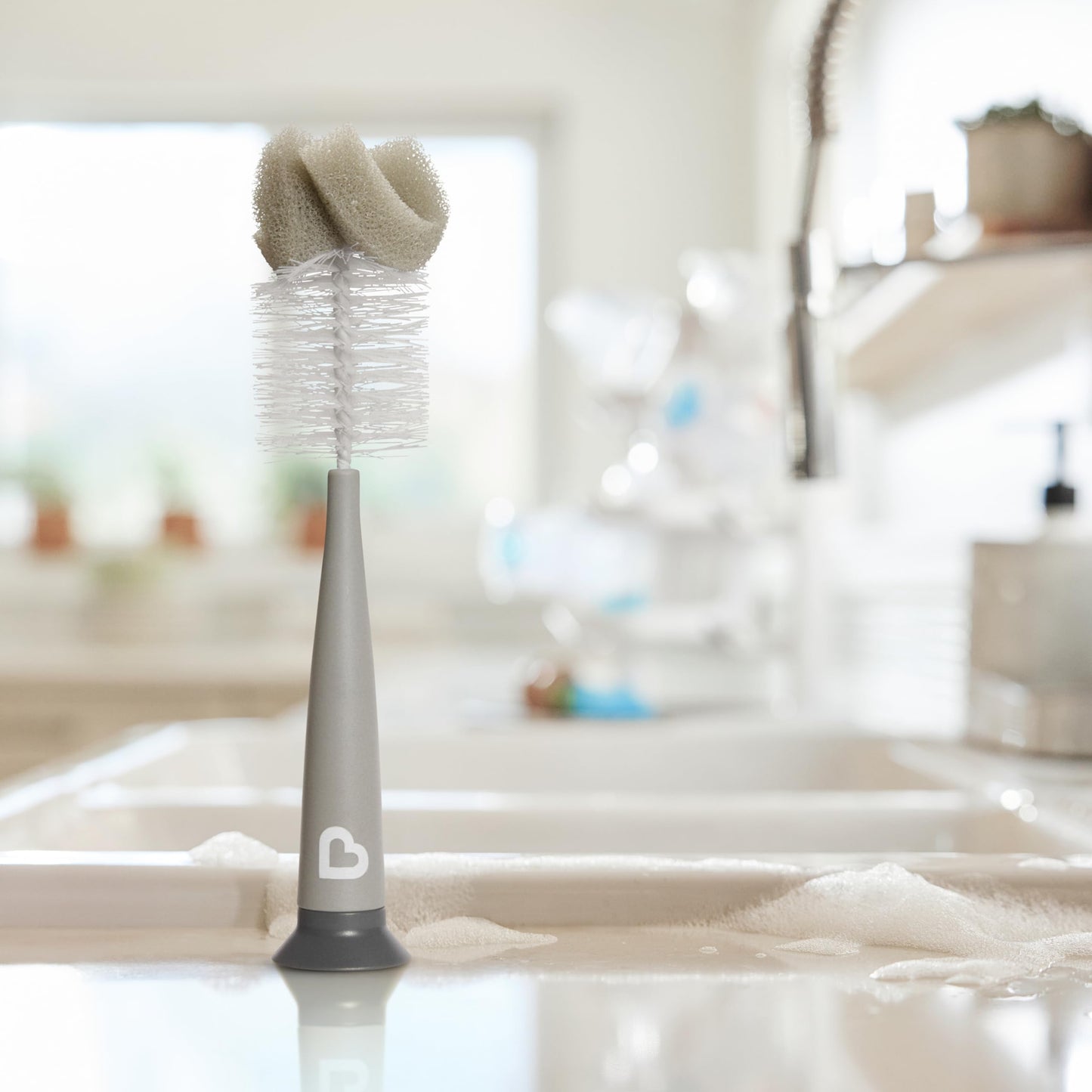Munchkin sponge bottle brush standing upright on counter