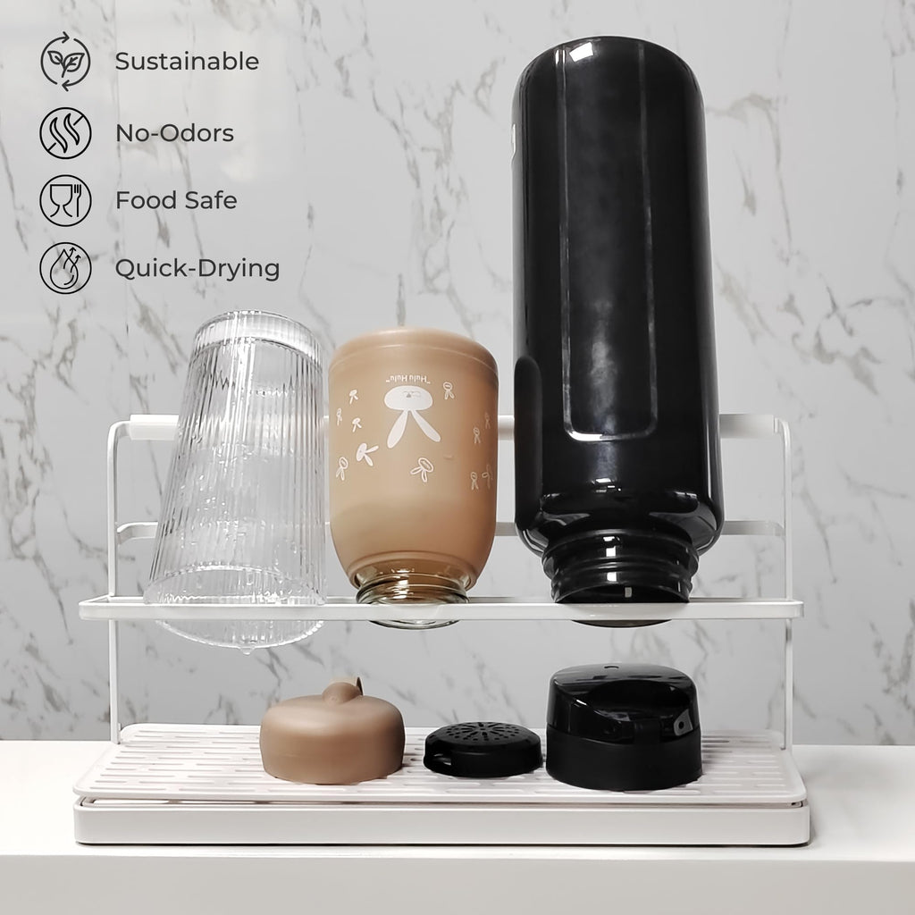 Narrow white bottle drying rack over kitchen sink